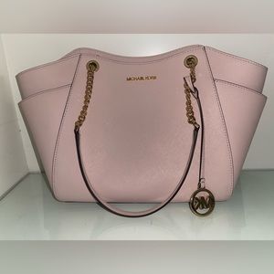Pinkish nude medium sized Michael Kors purse with gold accents.